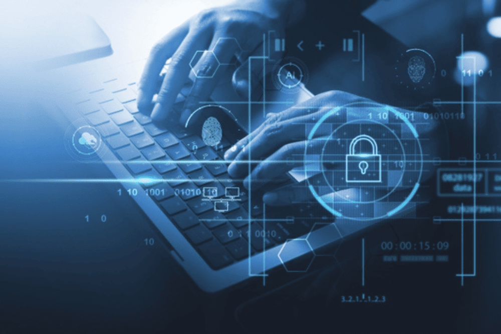Person typing on laptop with digital cybersecurity interface overlay.